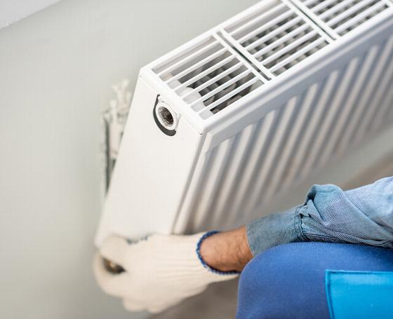 construction site with workers discussing building progress featuring three individuals in hard hats and safety vests working on a project with a crane in the background related to 7 essential construction practices